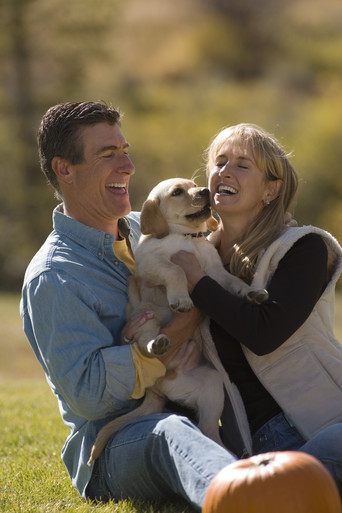 Image showing a couple playing with a dog